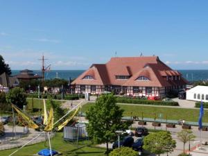 an amusement park with a roller coaster in front of a building at Möwe App 510 in Zingst +13 photos