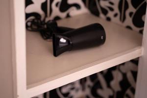 a black hair dryer sitting on a shelf at Appartement Cosy et Confortable in Casablanca