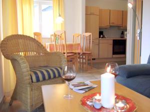a living room with a table with a candle and wine glasses at Meeresbrise 06 in Neuhaus