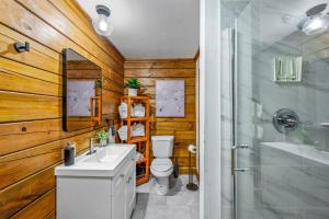 a bathroom with a toilet and a sink and a shower at Couples Getaway Cabin near National Park w Hot Tub in Pigeon Forge +35 photos