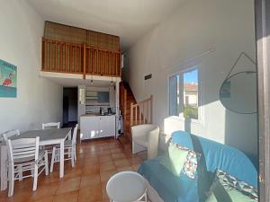 a living room and kitchen with a table and chairs at Appartement proche mer, parking, animaux acceptés - FR-1-475-159 in Saintes-Maries-de-la-Mer