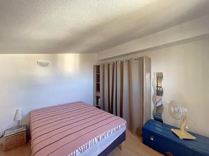 a small bedroom with a bed and a lamp at Appartement proche mer, parking, animaux acceptés - FR-1-475-159 in Saintes-Maries-de-la-Mer