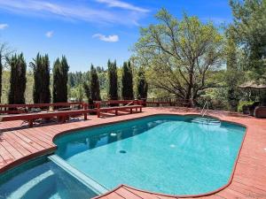 a swimming pool on a patio with two benches at Whole House at Eaglenest Inn with Pool & Seasonal SPA in Julian
