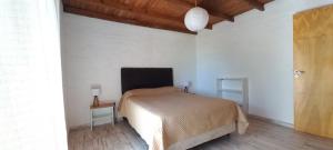 a bedroom with a bed and a wooden floor at FUJI - Casas para relajar in Villa de Las Rosas +277 photos