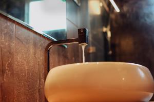 a bathroom sink with water coming out of a faucet at Sharta Yala in Tissamaharama +34 photos