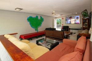 a living room with a couch and a tv at CStay in Picnic Bay
