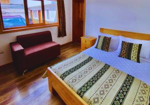 En eller flere senge i et værelse på Hotel Chasky Cuenca