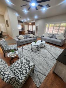 a living room with couches and chairs and tables at Bold Blue Retreat in Henderson in Las Vegas