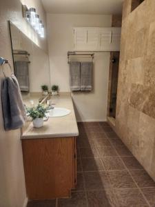 a bathroom with a sink and a mirror at Bold Blue Retreat in Henderson in Las Vegas +20 photos