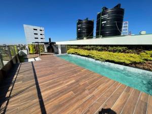 a deck on the roof of a building with two black tanks at Baruc GP in Santa Cruz de la Sierra