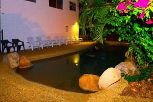 a pool of water with chairs in a building at CStay in Picnic Bay +36 photos