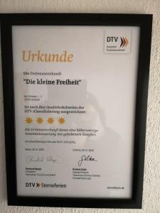 Un certificado, premio, cartel u otro documento en Die kleine Freiheit Grömitz Center - Unmittelbare Strandlage mit allem Komfort 13 fotos más