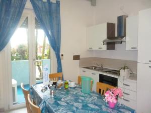 a kitchen with a table with a blue table cloth at Residence BluAdria in San Mauro a Mare