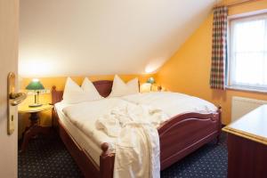 a bedroom with a bed with white sheets and a window at Park Resort in Willingen +30 photos