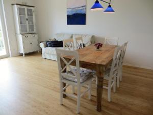 a wooden table and chairs in a living room at Dorothee V6W5 in Dierhagen