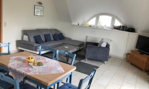 a living room with a couch and a table at "Koppeldeich" in Dierhagen