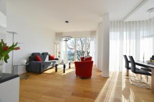 a living room with a red chair and a table at Suite Meersinn in Sassnitz