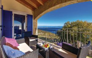 a patio with chairs and tables on a balcony at Gorgeous sea-view VillaSol with pool & BBQ in Zagorje
