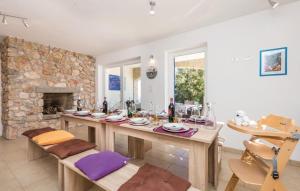 a dining room with a table and a fireplace at Gorgeous sea-view VillaSol with pool & BBQ in Zagorje