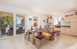 a kitchen with a table and benches in it at Gorgeous sea-view VillaSol with pool & BBQ in Zagorje +16 photos