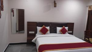a bedroom with a large bed in a room at Picket And Bhaskar Hotels Pvt Ltd in Srīkākulam