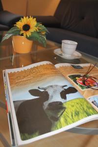 a book on a table with a picture of a cow at "Hof Triangel - Whg 2" - Bauernhofurlaub in Riepsdorf