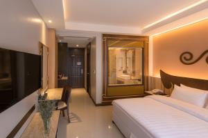 En eller flere senge i et værelse på Le Bali Resort & Spa