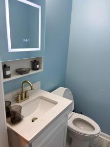 a bathroom with a sink and a toilet at CeloVacationHousing in Memphis +20 photos
