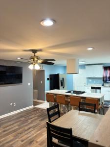 a kitchen with blue cabinets and a ceiling fan at CeloVacationHousing in Memphis