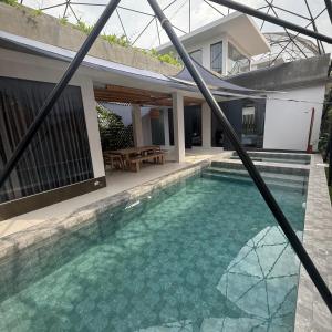 a swimming pool in front of a house at Huahin House Premium in Hua Hin