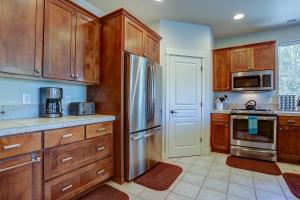 a kitchen with wooden cabinets and a stainless steel refrigerator at Quinn Creek in Bend