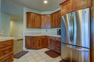 a kitchen with wooden cabinets and a stainless steel refrigerator at Quinn Creek in Bend