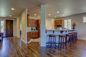 a kitchen with a bar with stools at Quinn Creek in Bend +33 photos
