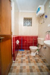 a bathroom with a toilet and a sink at Vacation homestay Goa in Aguada