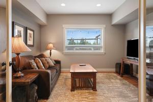 a living room with a couch and a window at Five Peaks in Bend