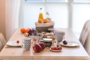 a table with plates of food and fruit on it at Lütten Kate 03 in Zingst