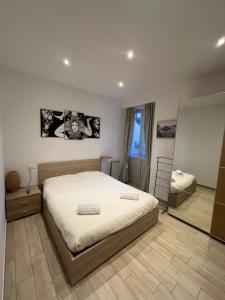 a bedroom with a large bed and a mirror at Avaja - Daria's apartment in Taormina