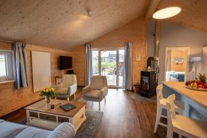 a living room with a couch and a table at Typ A plus "Schoner" -Skipperhaus- in Pelzerhaken