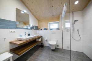 a bathroom with a shower and a sink and a toilet at Typ A plus "Schoner" -Skipperhaus- in Pelzerhaken +16 photos