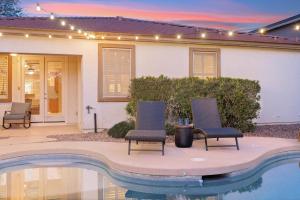 a house with two chairs and a swimming pool at Goodyear Springs in Goodyear