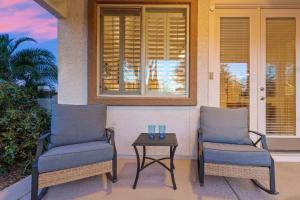 two chairs and a table on a porch at Goodyear Springs in Goodyear