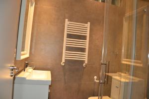 a bathroom with a shower with a toilet and a sink at Apartamento Larrabide in Pamplona