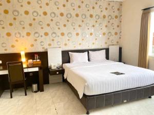 Postelja oz. postelje v sobi nastanitve Hotel 88 Jember By WH - Strategic Location In The City Center