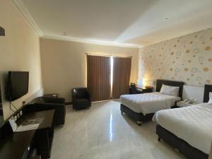 Postelja oz. postelje v sobi nastanitve Hotel 88 Jember By WH - Strategic Location In The City Center