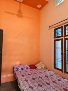 a bedroom with a bed and a window at Swastik HomeStay in Ayodhya +15 photos