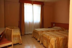 Letto o letti in una camera di Hotel Tre Torri