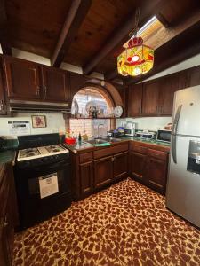 a kitchen with a stove and a sink and a refrigerator at Casa Rustica-secure parking included in Tijuana +3 photos