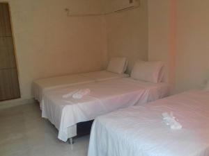 Voodi või voodid majutusasutuse Manzanillo Beach toas