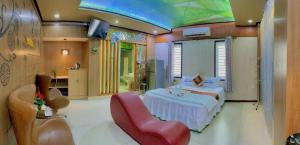 a bedroom with a bed and a red chair in it at Phương Anh 7 in Da Nang +13 photos