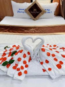 a bed with two towels made to look like hearts at Phương Anh 7- Only accept Vietnamese customers in Danang